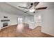 Open-concept living room featuring wood-look flooring, a fireplace, and a kitchen island for seamless entertaining at 2050 W Warm Springs Rd # 4512, Henderson, NV 89014