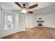 Spacious living room with wood-look floors, fireplace, and ceiling fan at 2050 W Warm Springs Rd # 4512, Henderson, NV 89014