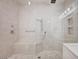 Modern, tiled shower with a built-in bench, rainfall shower head, and elegant fixtures at 2050 W Warm Springs Rd # 4512, Henderson, NV 89014