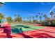 Brightly colored tennis court surrounded by Palm Trees on a sunny day at 2050 W Warm Springs Rd # 4512, Henderson, NV 89014