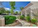 Street-level view of a stucco home with desert landscaping, a quaint gate, and light exterior paint at 2212 Warm Walnut Dr, Las Vegas, NV 89134