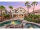 Beautiful backyard featuring a pool, spa, patio, landscaping, and palm trees with a view of the home at 2221 Grier Woods Ct, Las Vegas, NV 89134