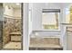 Elegant primary bathroom with a glass enclosed shower and a luxurious soaking tub at 2221 Grier Woods Ct, Las Vegas, NV 89134
