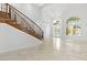 Spacious foyer boasting high ceilings, tile flooring, staircase and natural light from the front door at 2221 Grier Woods Ct, Las Vegas, NV 89134