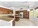 A spacious kitchen is furnished with a marble-topped island, stainless steel appliances, and beautiful wood cabinetry at 2221 Grier Woods Ct, Las Vegas, NV 89134