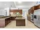 Well-appointed kitchen with stainless steel appliances, granite countertops, and dark wood cabinets at 2221 Grier Woods Ct, Las Vegas, NV 89134