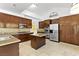 Modern kitchen featuring stainless steel appliances, granite countertops, a center island, and dark wood cabinets at 2221 Grier Woods Ct, Las Vegas, NV 89134