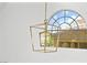 Close-up of a modern, geometric light fixture hanging near a window at 2221 Grier Woods Ct, Las Vegas, NV 89134