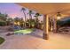 Outdoor pool with a rock waterfall feature and lush landscaping at 2221 Grier Woods Ct, Las Vegas, NV 89134