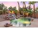 Private backyard with pool, rock waterfall, and beautiful landscaping at 2221 Grier Woods Ct, Las Vegas, NV 89134