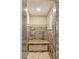 Elegant shower with beautiful stone and a built-in shower seat at 2221 Grier Woods Ct, Las Vegas, NV 89134