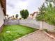 Backyard featuring artificial grass, mature trees, gravel, and block wall for privacy at 2705 Chokecherry Ave, Henderson, NV 89074