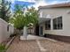 Backyard featuring a covered patio, rock landscaping, a privacy wall and mature trees at 2705 Chokecherry Ave, Henderson, NV 89074