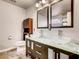 Bathroom featuring double vanity with vessel sinks, dark cabinetry, and linen closet at 2705 Chokecherry Ave, Henderson, NV 89074