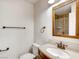 Bathroom featuring neutral walls, granite countertop, bronze fixtures, a towel rack and a step-in shower at 2705 Chokecherry Ave, Henderson, NV 89074