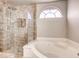 Bright bathroom with a tub, separate shower, and decorative window at 2705 Chokecherry Ave, Henderson, NV 89074