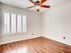 Bedroom with hardwood flooring, window with plantation shutters, and ceiling fan at 2705 Chokecherry Ave, Henderson, NV 89074