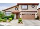 Charming two-story home featuring a well-manicured lawn and a two-car garage at 2705 Chokecherry Ave, Henderson, NV 89074