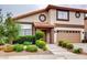 Charming two-story home showcasing a well-maintained lawn and an attached garage at 2705 Chokecherry Ave, Henderson, NV 89074