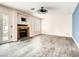 Bright living room with a decorative ceiling fan and cozy fireplace at 2705 Chokecherry Ave, Henderson, NV 89074