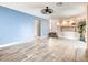 Open concept living room with stairs leading to second level and view to kitchen at 2705 Chokecherry Ave, Henderson, NV 89074