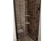 Shower stall featuring neutral tiles, glass door, and two corner shelves for toiletries at 2705 Chokecherry Ave, Henderson, NV 89074