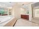 Luxurious bathroom featuring a soaking tub and a vanity with dark wood cabinets and marble countertop at 2747 Paradise Rd # 2704, Las Vegas, NV 89109