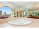 Elegant bathroom featuring a soaking tub, mirrored walls, and city views at 2747 Paradise Rd # 2704, Las Vegas, NV 89109