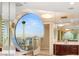 Modern bathroom design with a round mirror offering a panoramic view of the Las Vegas cityscape at 2747 Paradise Rd # 2704, Las Vegas, NV 89109