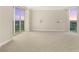 Spacious bedroom with carpet, neutral paint, sconces, and floor-to-ceiling windows at 2747 Paradise Rd # 2704, Las Vegas, NV 89109