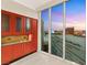 Spacious kitchen includes custom cabinets, granite counters, and city views through large windows at 2747 Paradise Rd # 2704, Las Vegas, NV 89109