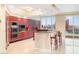 Spacious kitchen featuring granite countertops, stainless steel appliances, red cabinets and city views at 2747 Paradise Rd # 2704, Las Vegas, NV 89109