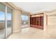Open-concept living area with built-in shelves, light tile flooring and balcony access, offering city views at 2747 Paradise Rd # 2704, Las Vegas, NV 89109