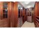 Spacious walk-in closet with custom wood cabinets, drawers, and shelving for organized storage at 2747 Paradise Rd # 2704, Las Vegas, NV 89109