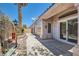 Backyard patio area with desert landscaping and sliding glass door access at 2889 Anteres St, Las Vegas, NV 89117