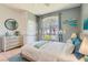 Calming bedroom with a large window, light grey walls, and a cozy, well-lit ambiance at 2889 Anteres St, Las Vegas, NV 89117
