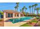 Beautiful community pool with palm trees, clear water and lounge seating on a sunny day at 2889 Anteres St, Las Vegas, NV 89117