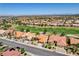 A high-altitude aerial view shows golf course frontage for homes in a desert community at 3120 Darby Falls Dr, Las Vegas, NV 89134