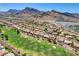 Beautiful aerial view of a golf course community with mountain views in the background at 3120 Darby Falls Dr, Las Vegas, NV 89134
