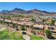 Beautiful aerial view of homes in a community, showcasing a golf course and mountain range in the background at 3120 Darby Falls Dr, Las Vegas, NV 89134