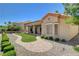 The backyard features a manicured lawn, desert landscaping, and a brick walkway to the patio at 3120 Darby Falls Dr, Las Vegas, NV 89134