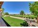 This home has a scenic backyard featuring desert landscaping, a small turf area, and views of the golf course at 3120 Darby Falls Dr, Las Vegas, NV 89134