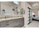 Bathroom featuring double vanity with gray cabinets and an adjacent bedroom at 3120 Darby Falls Dr, Las Vegas, NV 89134