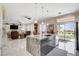 Open-concept kitchen with an island and breakfast bar, stainless steel appliances, and a view to the backyard at 3120 Darby Falls Dr, Las Vegas, NV 89134