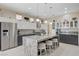 Bright kitchen featuring modern appliances, a central island with bar stool seating, and updated cabinetry at 3120 Darby Falls Dr, Las Vegas, NV 89134