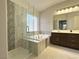 Elegant bathroom with a separate shower, soaking tub, stylish tile work, and a double vanity at 33 Hatten Bay St, Henderson, NV 89012