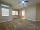 Spacious bedroom offers plush carpet, natural light from multiple windows, and an ensuite bathroom at 33 Hatten Bay St, Henderson, NV 89012