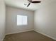 Cozy bedroom offers a ceiling fan, neutral walls, and a bright window with serene neighborhood views at 33 Hatten Bay St, Henderson, NV 89012