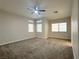 Neutral bedroom features plush carpeting, multiple windows for natural light, and a ceiling fan at 33 Hatten Bay St, Henderson, NV 89012