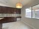 Eat-in kitchen with dark cabinets, granite countertops, and a large window at 33 Hatten Bay St, Henderson, NV 89012